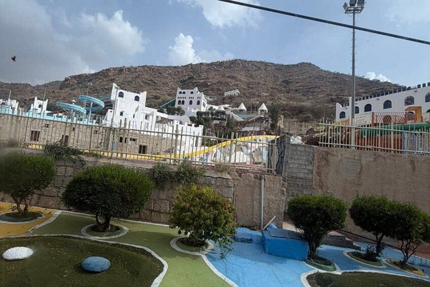 A water park with slides and a mountainous backdrop. 2