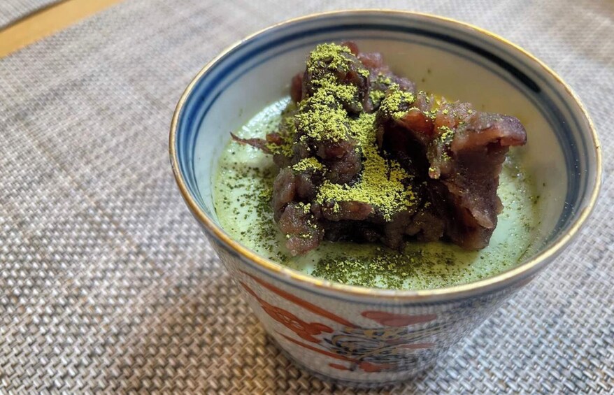 A cup of matcha tea with a decorative pattern. 4