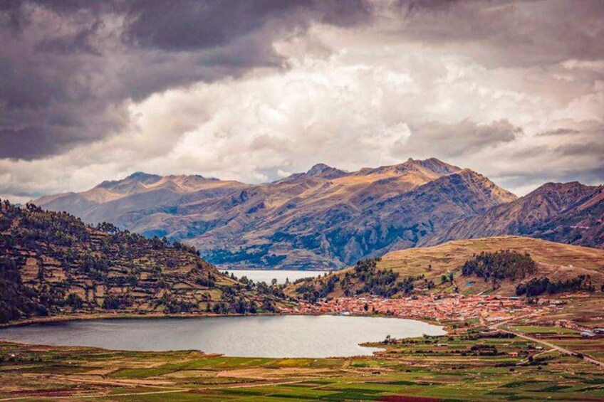 A mountainous landscape with a lake and a small settlement. 2