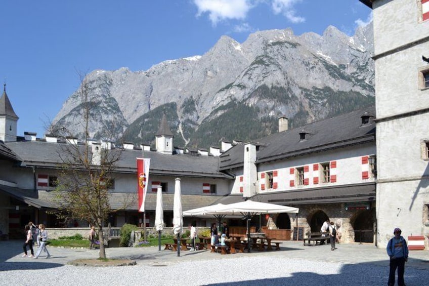A mountain village with buildings, a café, and a mountain backdrop. 2