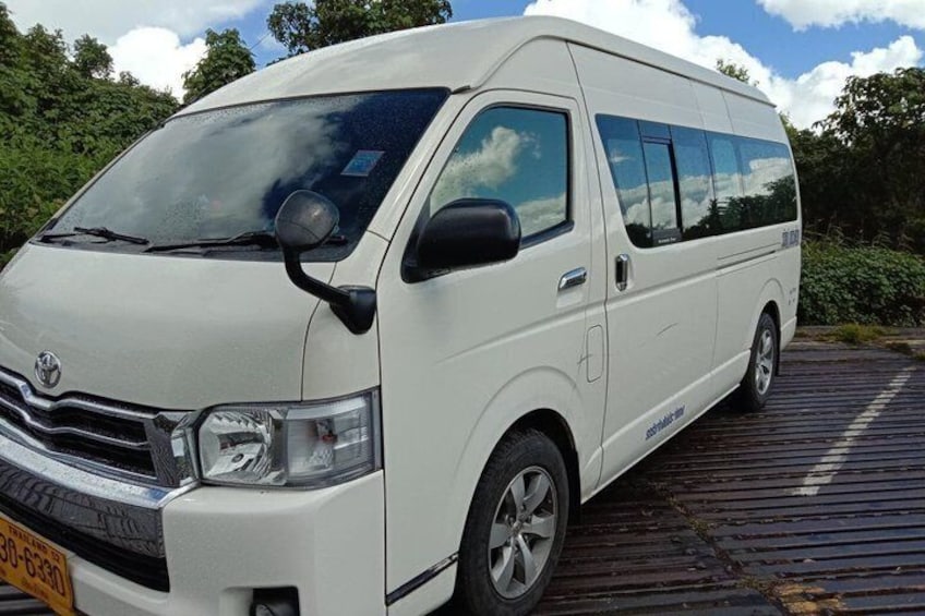 A white van parked on a wooden dock. 1