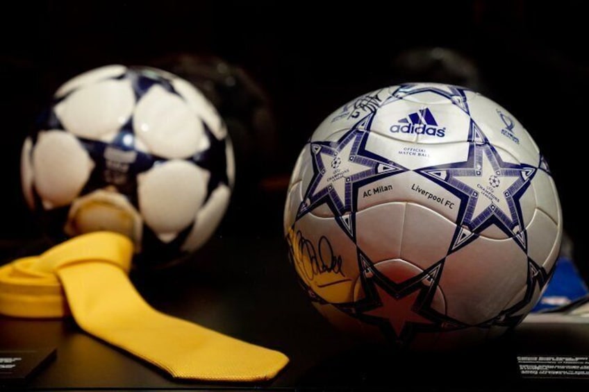 Two soccer balls with star patterns, one with a yellow cloth and another with a signature. 5