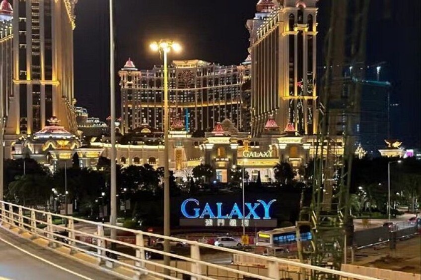 A brightly lit hotel with a prominent 'GALAXY' sign. 5