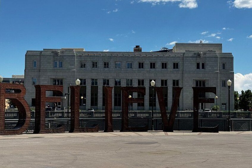 A building with large letters spelling 'BELIEVE' in front of it. 5