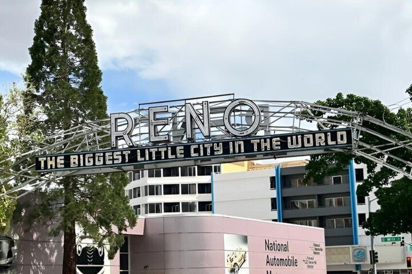 A sign reading 'RENO THE BIGGEST LITTLE CITY IN THE WORLD' with a modern building in the background. 4