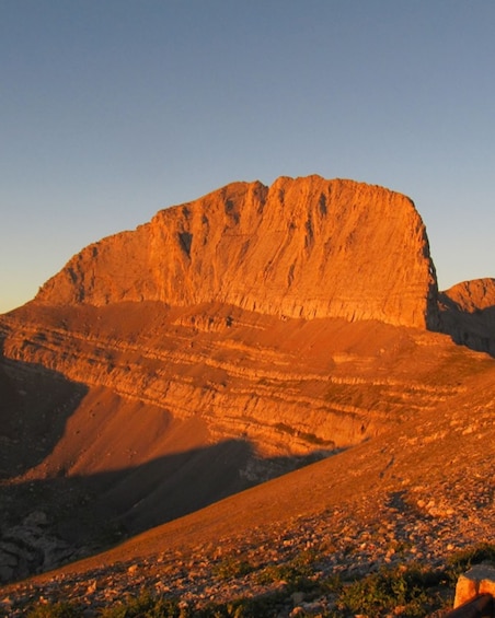 A large, steep mountain with a clear sky. 2