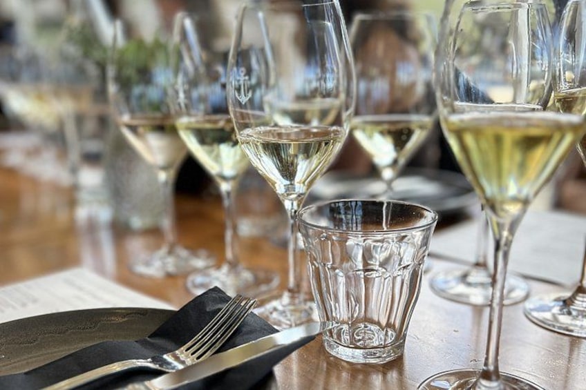 A table with wine glasses and a fork. 2