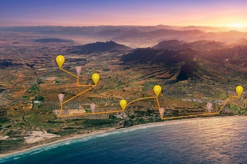 An aerial view of a coastal landscape with numbered markers indicating a route or points of interest. 1