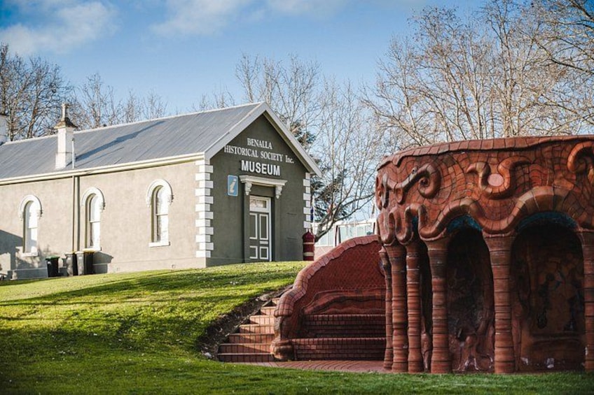 A museum with a brick facade and a stone archway. 4