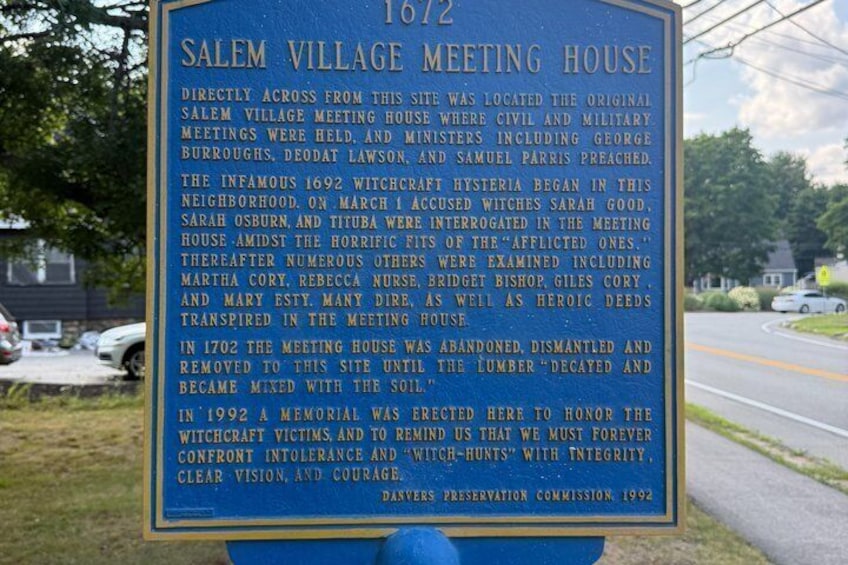 A historical marker sign with text about Salem Village Meeting House. 3