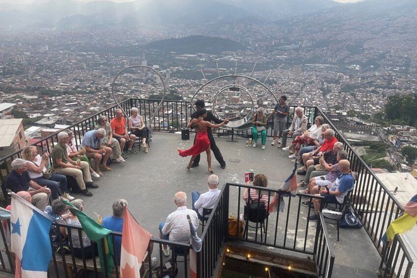 A person performing in a circular area with an audience seated around. 2