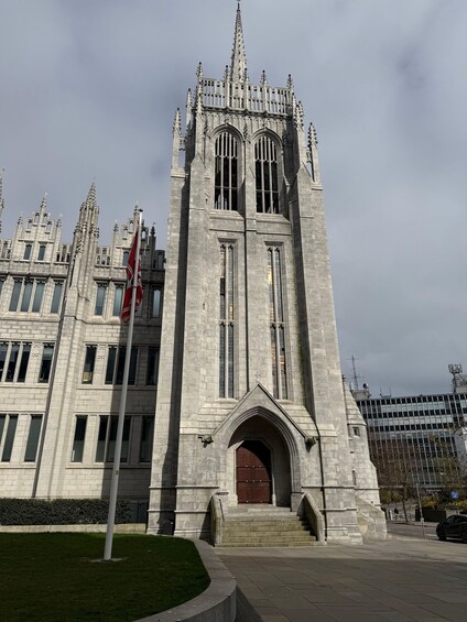 A Gothic-style church with a tall spire and arched windows. 5
