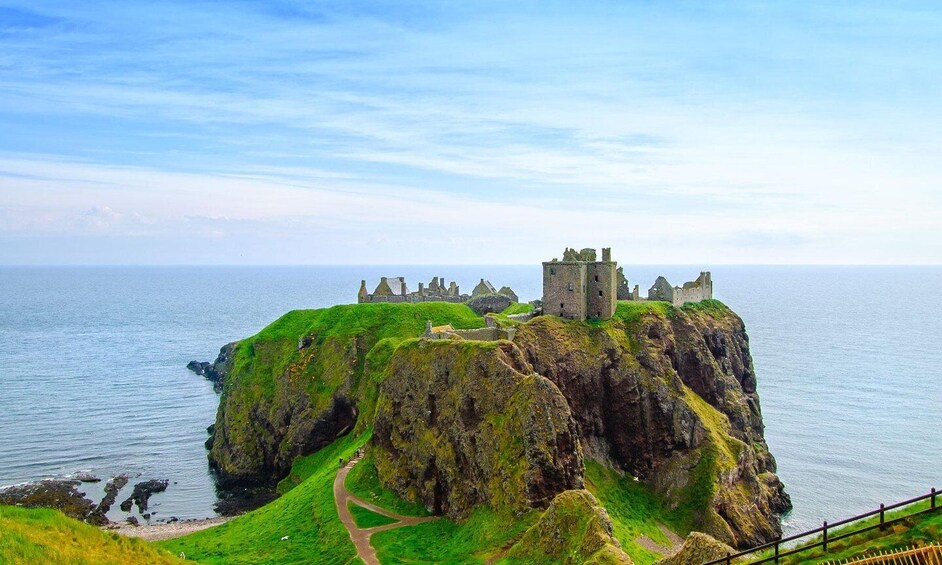 A castle on a green cliff by the sea. 2