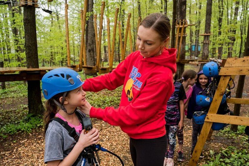 An outdoor activity with a person in a red hoodie and a child in a blue helmet. 3