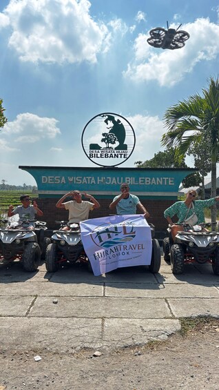 A group of people on ATVs in front of a sign for Desa Wisata Hijau Bilebante. 5