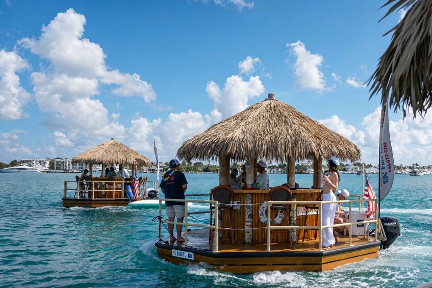 A boat with a thatched roof and people on it, surrounded by water and other boats. 3