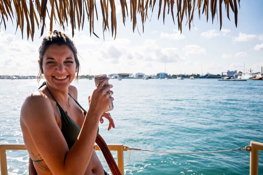 A person on a boat with a view of the water and boats in the background. 4