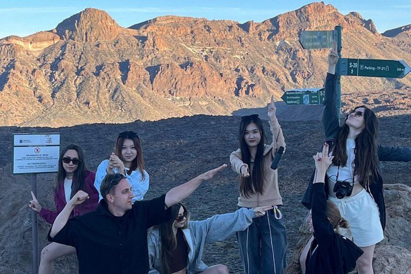 A group of people posing with a mountain range in the background. 5