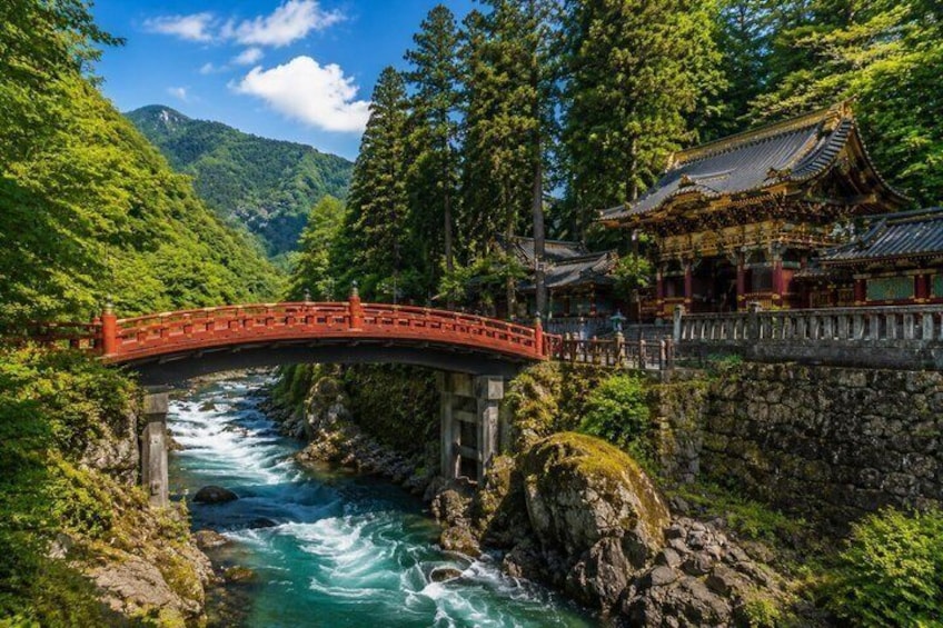 A red bridge over a river, surrounded by lush greenery and a traditional building. 4