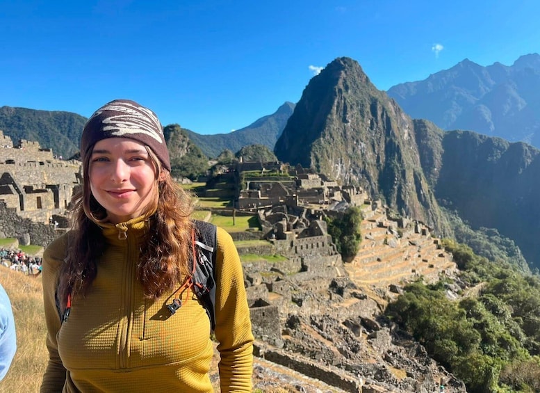 A person standing in front of Machu Picchu with the mountain in the background. 1