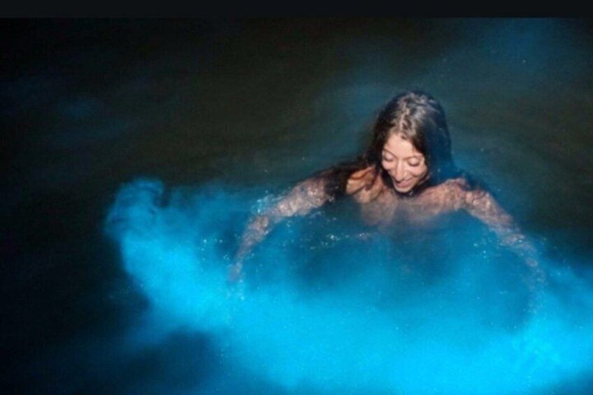 A person in water with blue smoke or mist around them. 2