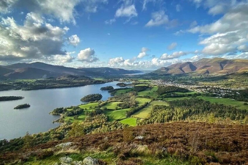 A lake surrounded by hills and a town. 1