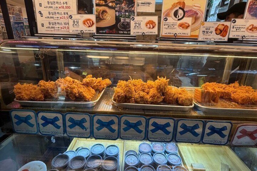 A food display with fried chicken and various sauces. 2