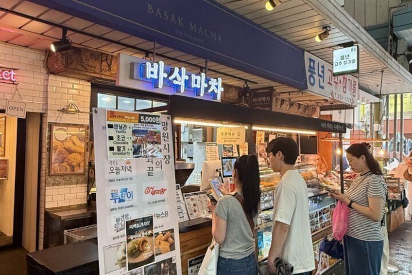 A food stall with a signboard and a menu. 4