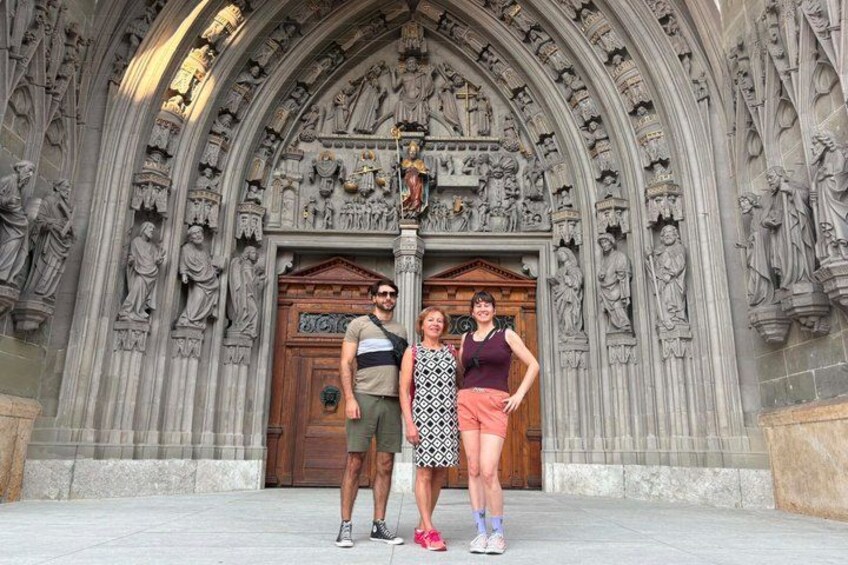 A Gothic-style building with intricate stone carvings and a wooden door. 1