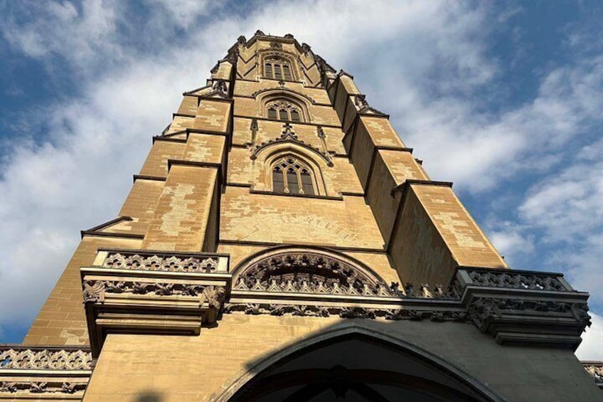 A tall, ornate tower with intricate architectural details and a clear sky in the background. 3