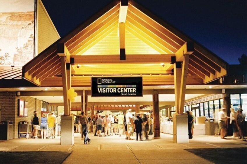 A National Geographic Visitor Center with a large entrance and people walking in and out. 2