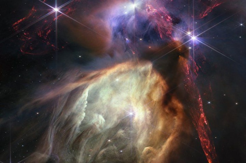 A nebula with bright stars and a large cloud of gas and dust. 2