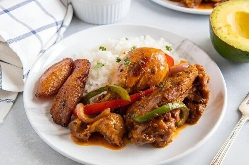 A plate of food with rice, meat, and vegetables. 2