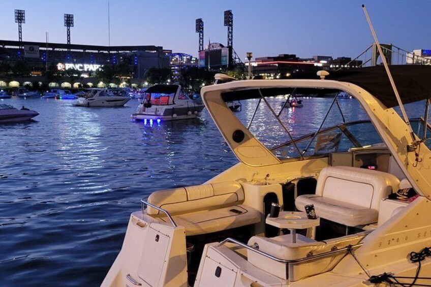 A boat docked at a marina with other boats in the background. 2