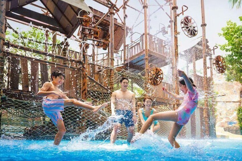 A water park with a rope bridge and water splashes. 4