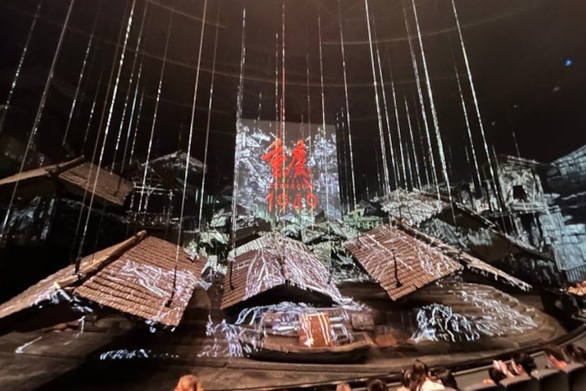 A model ship with multiple masts and a central red figure. 3