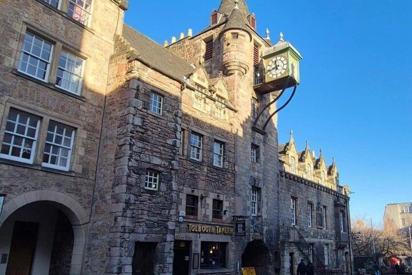 A historic stone building with a clock tower, arched windows, and a sign that reads 'TOLEDO TEA ROOM'. 3