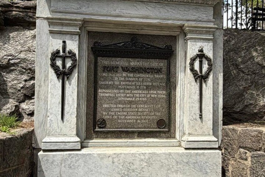 A memorial plaque with historical text and two decorative keys. 4