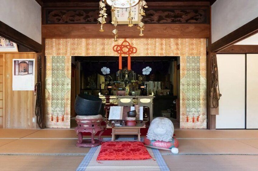 A traditional Japanese interior with tatami flooring, a shoji screen, and a hanging scroll. 2