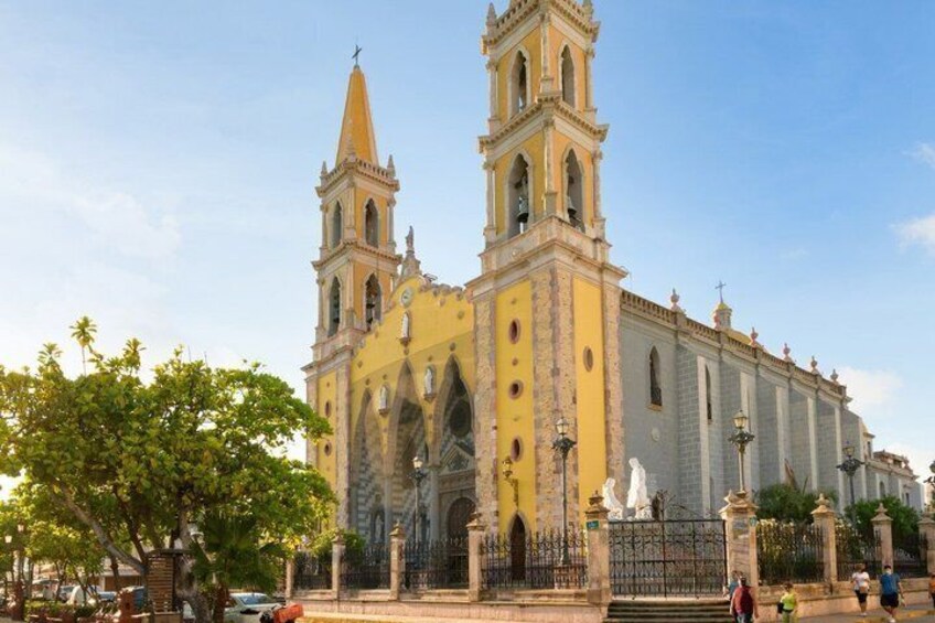 A historic church with a tall bell tower and a large arched entrance. 4
