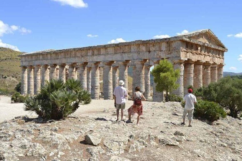 Ancient Greek ruins with columns and visitors. 1