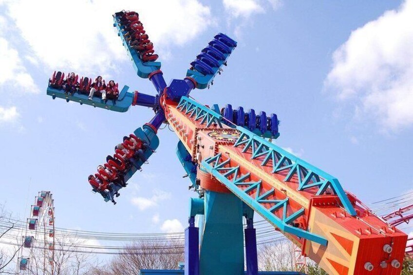 A colorful amusement park ride with a long, winding track and multiple cars. 1