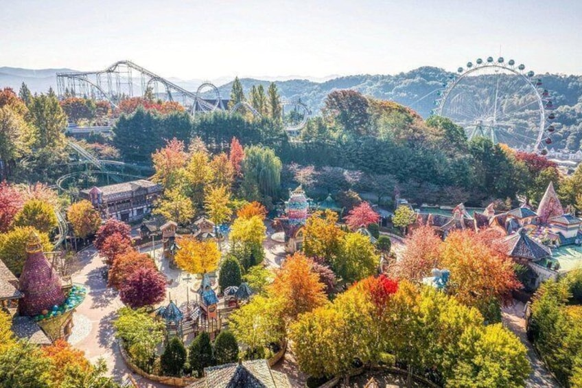 A theme park with colorful autumn trees, a roller coaster, and a Ferris wheel. 4