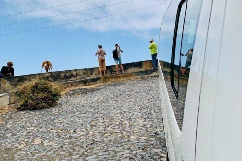 A rocky slope with people standing and observing. 4