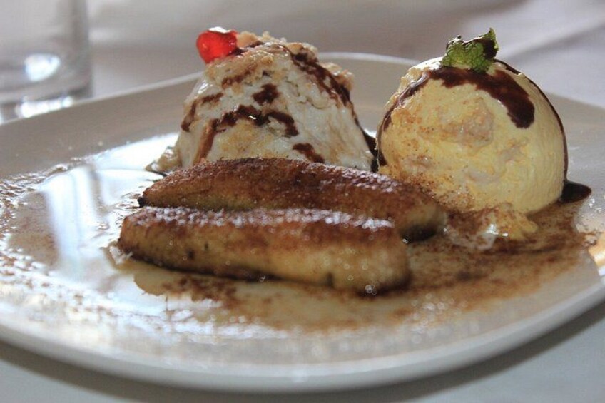 A dessert plate with ice cream and a pastry. 5