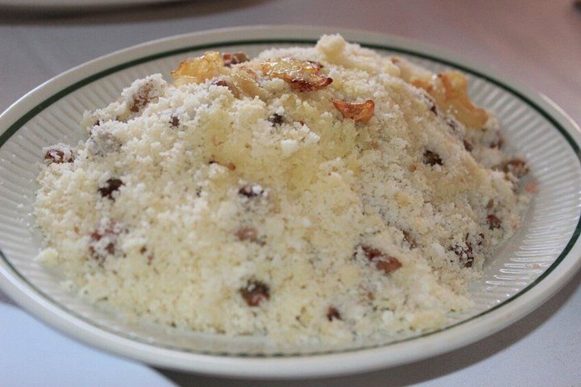 A plate of food with a creamy texture and visible nuts. 3