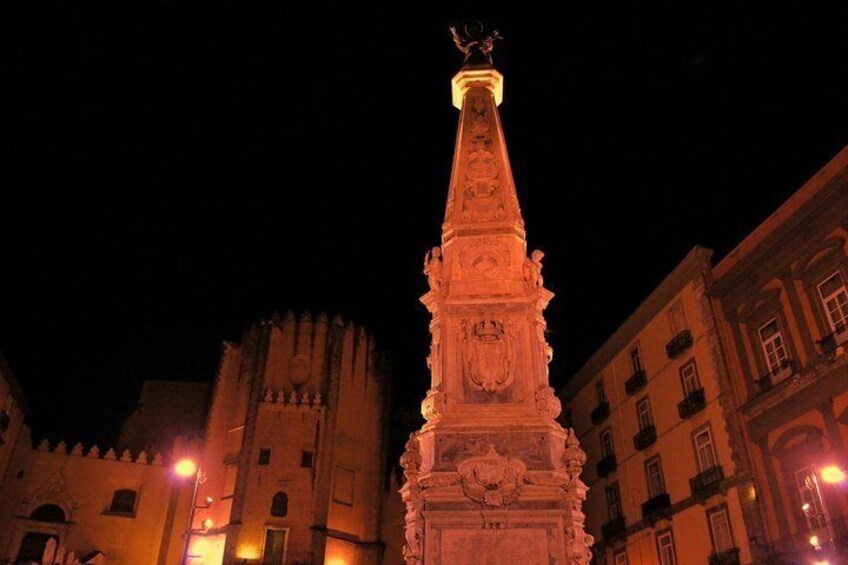 A tall, ornate tower with intricate carvings, set against a night sky. 3