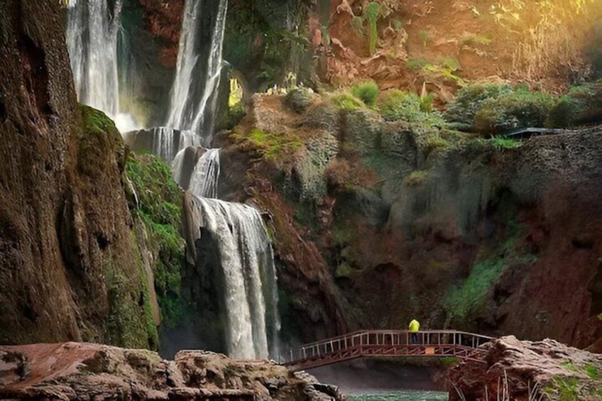 A waterfall, a rocky terrain, and a bridge. 1