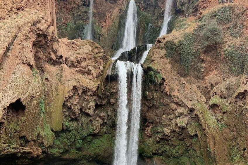 A multi-tiered waterfall cascading down rocky terrain. 2