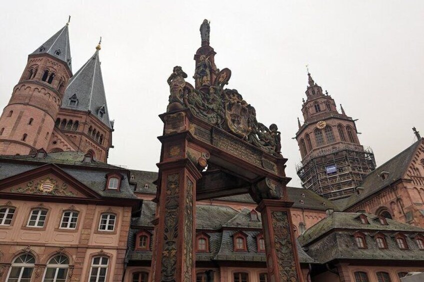 A historic building with ornate architecture, including a prominent archway and towers. 1
